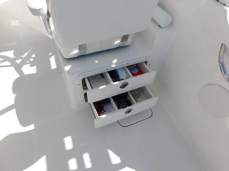 Slide: The Image of 2020 World Cat 230 DC boat interior with open storage drawers. - 16