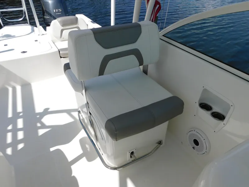 Slide: The Image of 2020 World Cat 230 DC boat interior with cushioned seating and cup holders. - 18