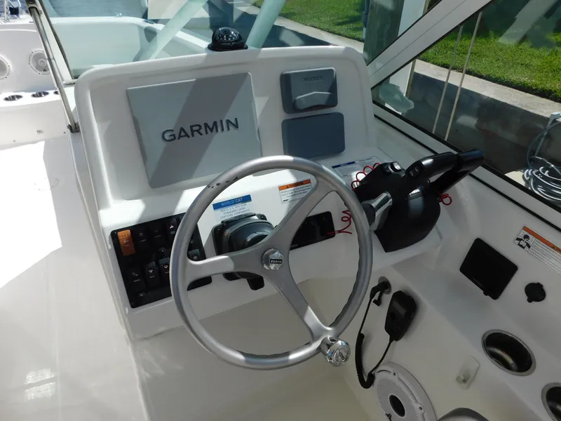 Slide: The Image of 2020 World Cat 230 DC boat dashboard with Garmin navigation system and steering wheel. - 22