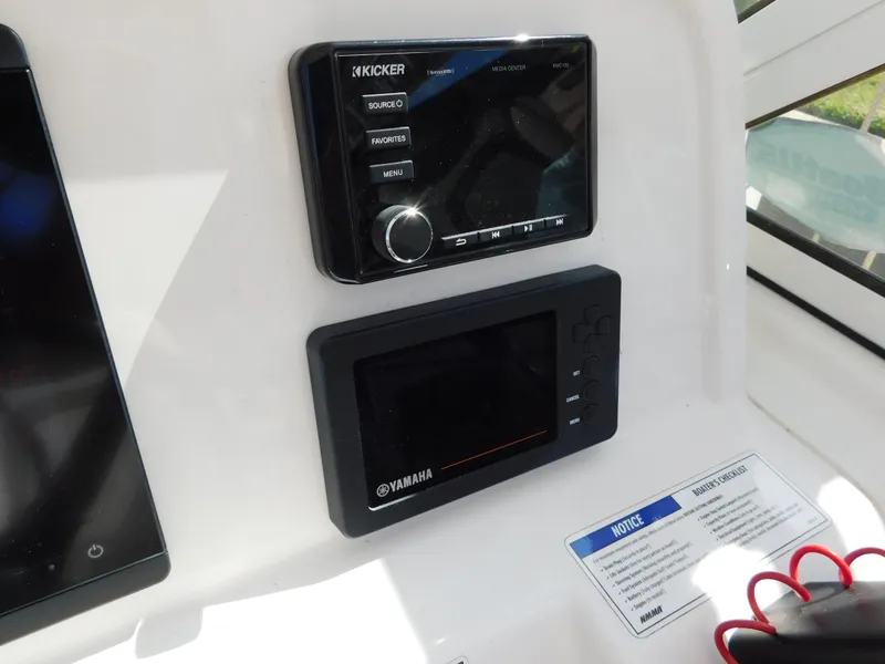 Slide: The Image of 2020 World Cat 230 DC dashboard with Kicker and Yamaha displays. - 23