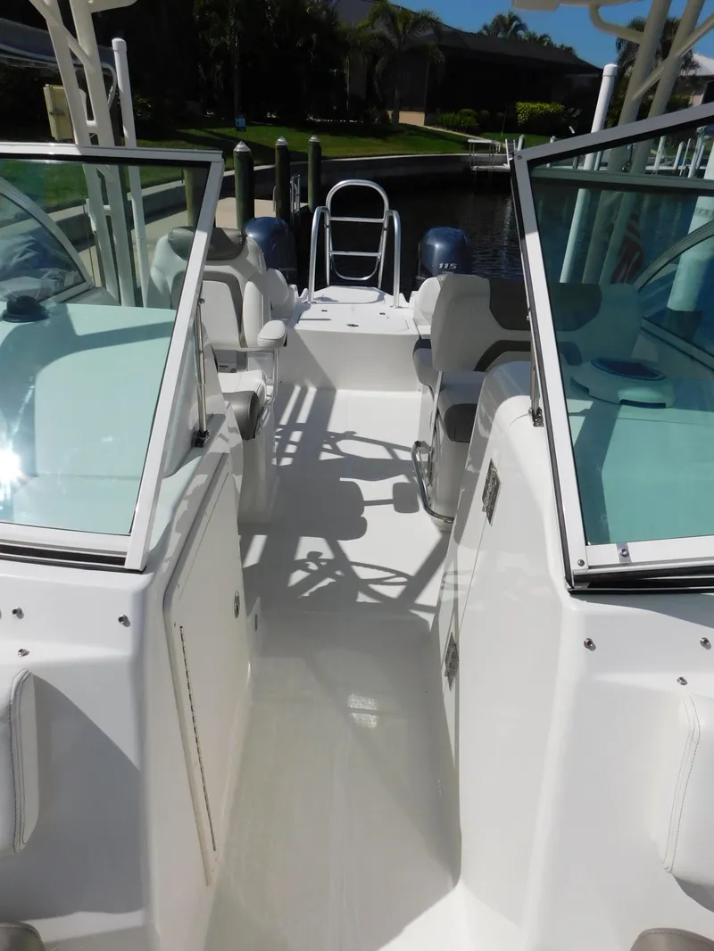 Slide: The Image of 2020 World Cat 230 DC boat interior with dual consoles and seating. - 33