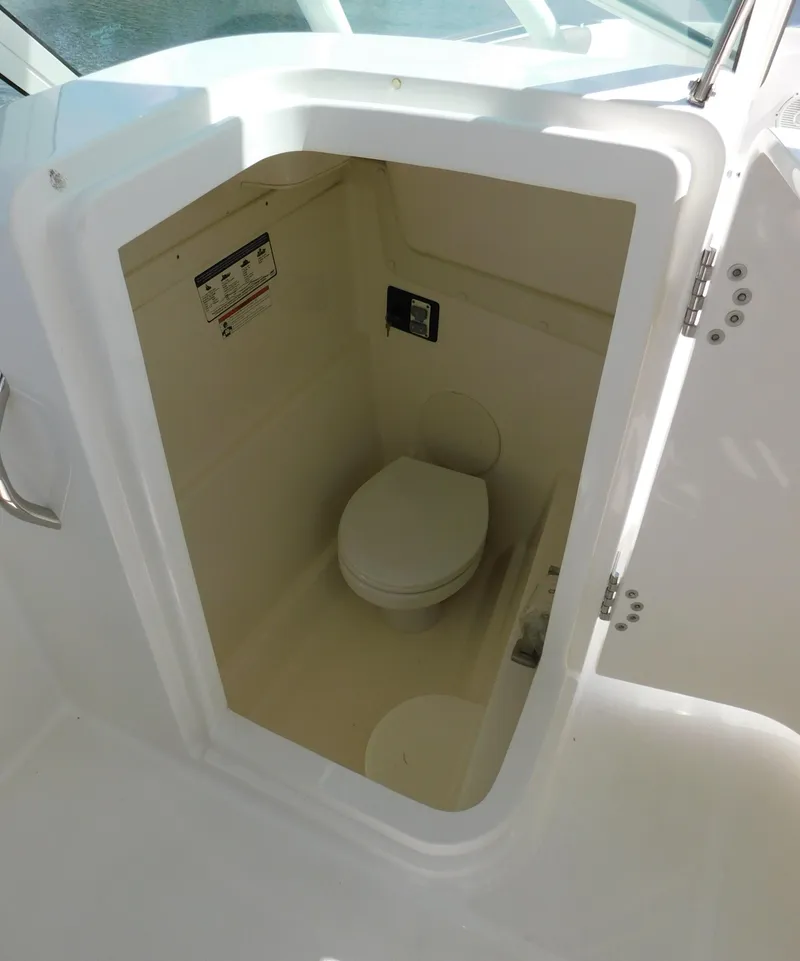 Slide: The Image of 2020 World Cat 230 DC boat interior with compact marine toilet. - 34