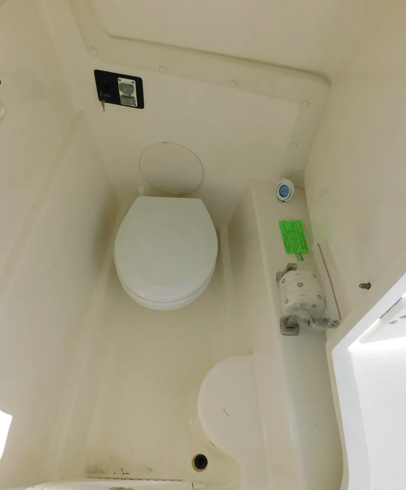 Slide: The Image of 2020 World Cat 230 DC boat interior with compact marine toilet. - 35