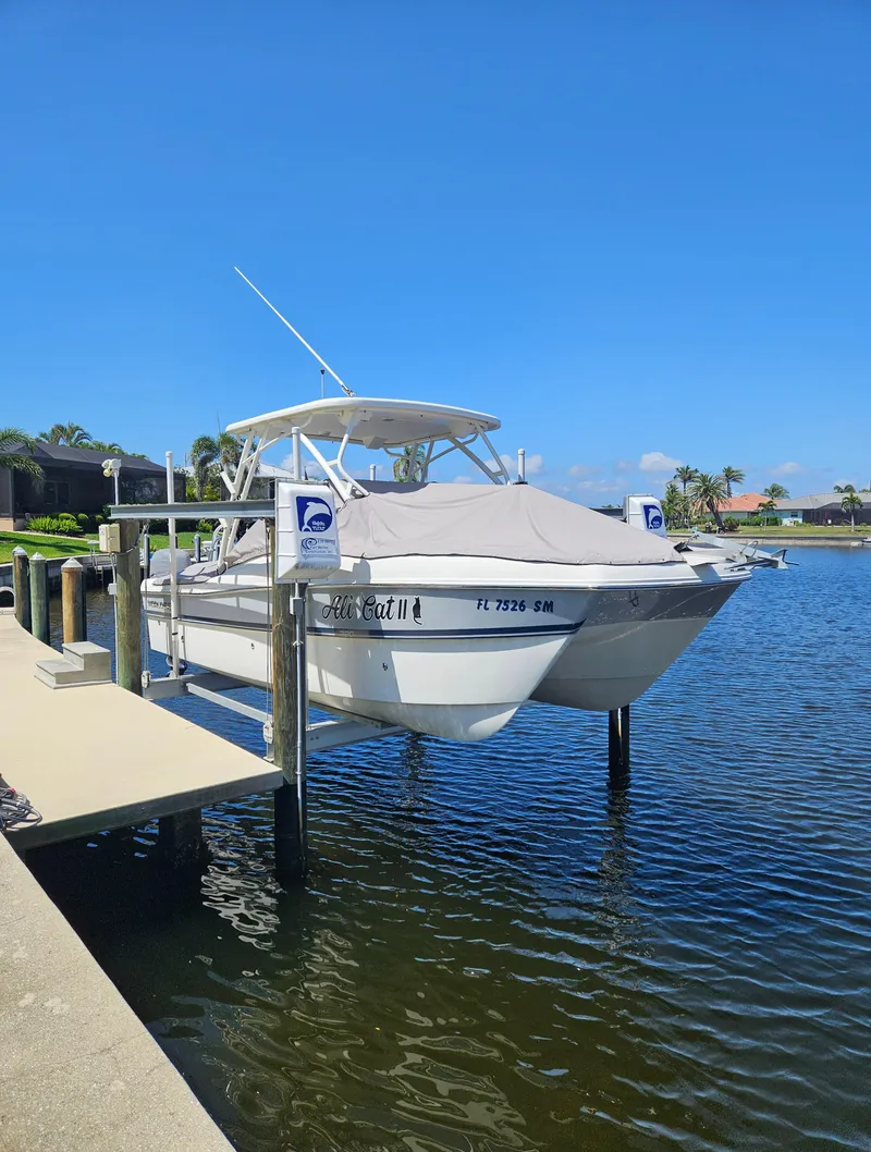 Slide: The Image of 2020 World Cat 230 DC boat docked on a sunny day by the water. - 4
