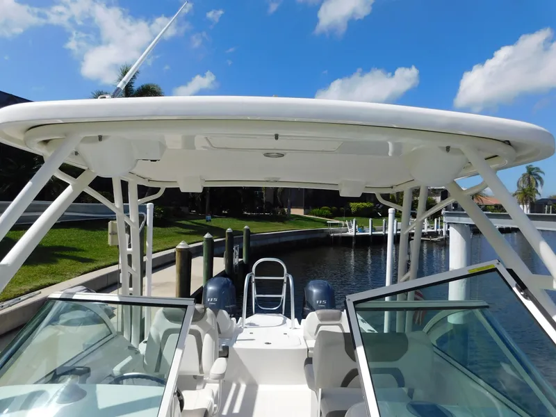 Slide: The Image of 2020 World Cat 230 DC boat with dual engines, docked under a clear blue sky. - 40