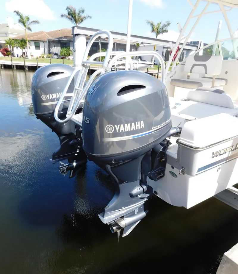 Slide: The Image of 2020 World Cat 230 DC with dual Yamaha outboard motors docked by waterfront homes. - 7