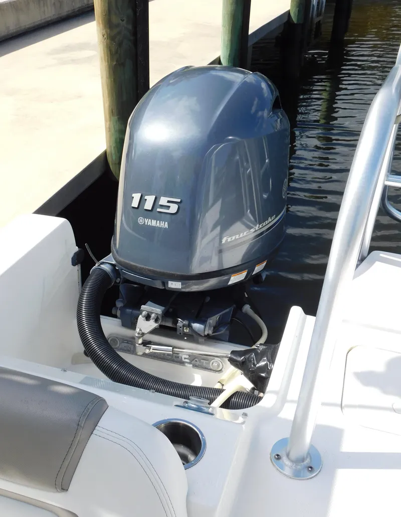 Slide: The Image of 2020 World Cat 230 DC boat with Yamaha 115 outboard motor docked by water. - 9