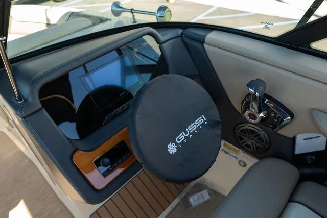 Slide: The Image of 2025 Chris-Craft 25 Sportster dashboard with Gussi Italia steering wheel cover. - 16