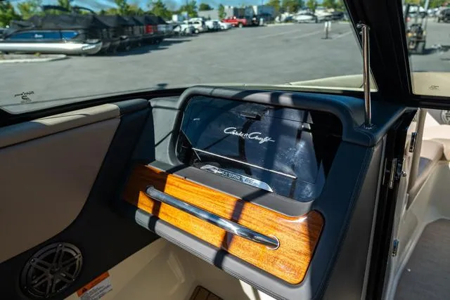 Slide: The Image of 2025 Chris-Craft 25 Sportster dashboard with wood accents and sleek design. - 20