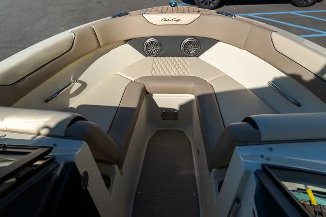 Slide: The Image of 2025 Chris-Craft 25 Sportster boat interior with beige seating and speakers. - 21