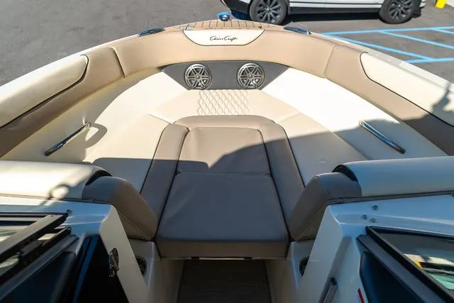 Slide: The Image of 2025 Chris-Craft 25 Sportster boat interior with beige seating and speakers. - 22