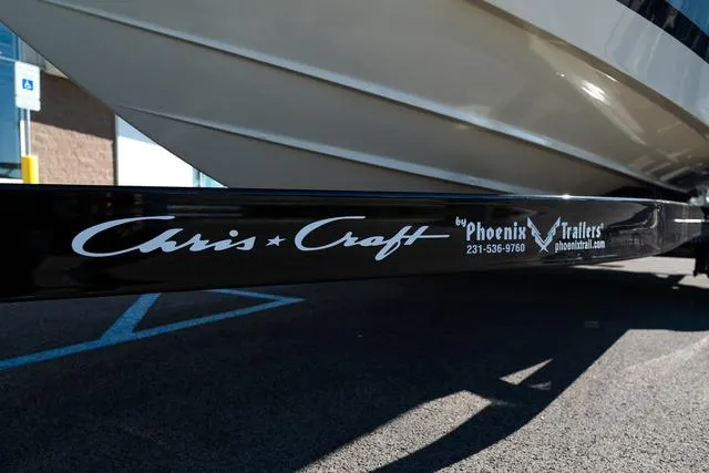 Slide: The Image of Chris-Craft 25 Sportster 2025 boat on Phoenix trailer in parking lot. - 4