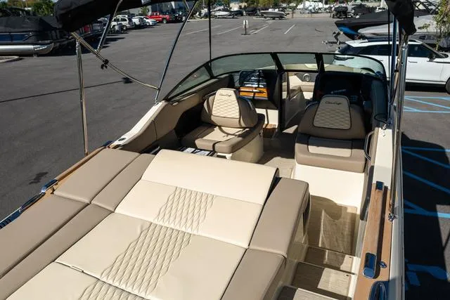 Slide: The Image of 2025 Chris-Craft 25 Sportster boat interior with beige seating and modern design. - 6