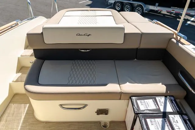 Slide: The Image of 2025 Chris-Craft 25 Sportster boat interior with cushioned seating and storage compartments. - 9