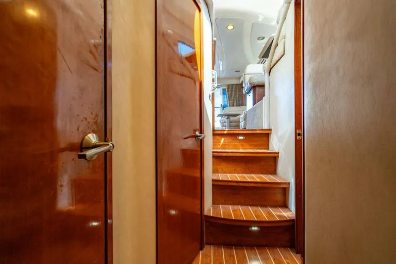 Slide: The Image of Interior of 1999 Sea Ray 56 Sedan Bridge with wooden stairs and doors. - 15
