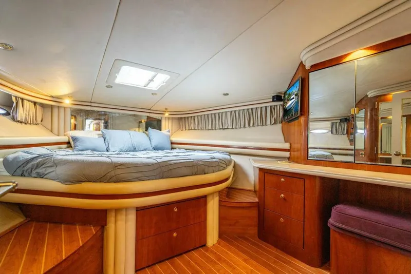Slide: The Image of Luxurious cabin interior of 1999 Sea Ray 56 Sedan Bridge yacht with wood accents. - 17