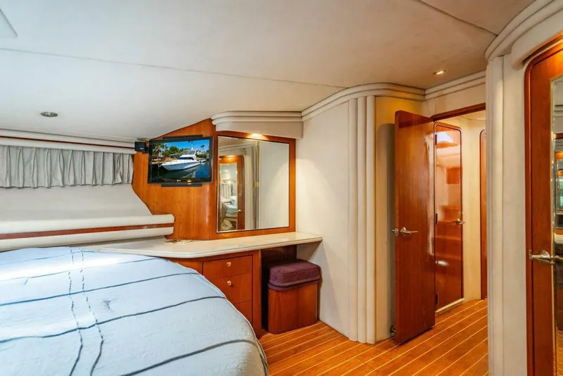 Slide: The Image of Luxurious cabin interior of 1999 Sea Ray 56 Sedan Bridge yacht with wood accents and cozy bedding. - 18