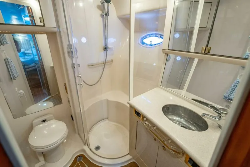 Slide: The Image of Luxurious bathroom in 1999 Sea Ray 56 Sedan Bridge yacht with shower and sink. - 19