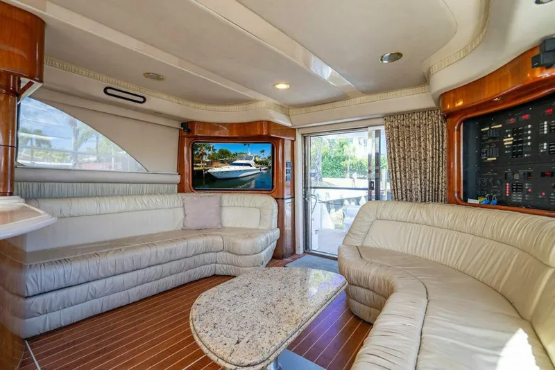 Slide: The Image of Luxurious interior of 1999 Sea Ray 56 Sedan Bridge yacht with plush seating and elegant decor. - 2