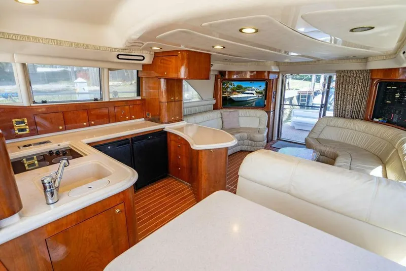 Slide: The Image of Luxurious interior of 1999 Sea Ray 56 Sedan Bridge yacht with modern kitchen and seating area. - 3