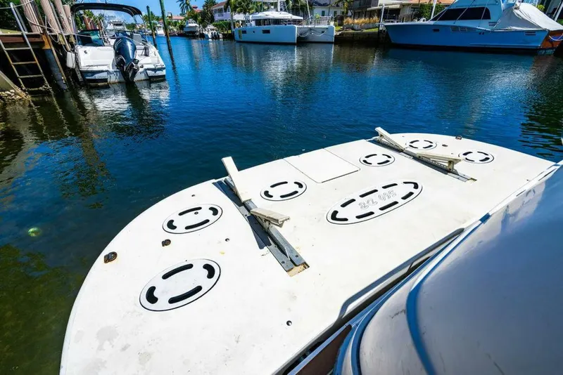 Slide: The Image of 1999 Sea Ray 56 Sedan Bridge yacht docked in a sunny marina. - 36