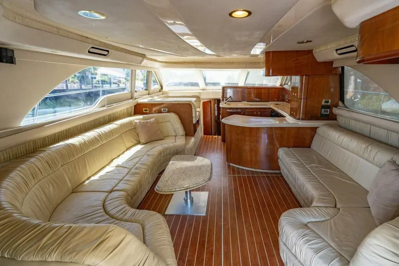 Slide: The Image of Luxurious interior of 1999 Sea Ray 56 Sedan Bridge yacht with plush seating and wood finishes. - 8