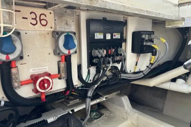 Slide: The Image of Electrical panel and wiring inside a 1980 Huckins Sports Cruiser boat. - 26