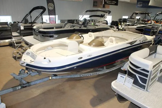 Slide: The Image of 2005 Kayot V220i boat on trailer, parked outdoors near vehicles and trees. - 3