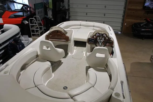 Slide: The Image of 2005 Kayot V220i boat dashboard with wood paneling and steering wheel. - 6