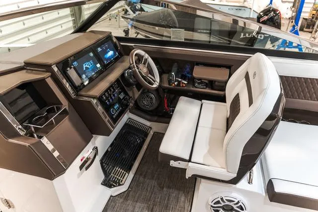 Slide: The Image of 2025 Cobalt R33 boat interior with modern dashboard and comfortable seating. - 20