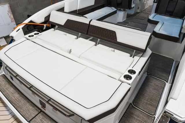 Slide: The Image of 2025 Cobalt R33 boat interior with white seating and cup holders. - 3