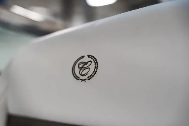 Slide: The Image of 2025 Cobalt R33 interior detail with embroidered logo on white upholstery. - 35