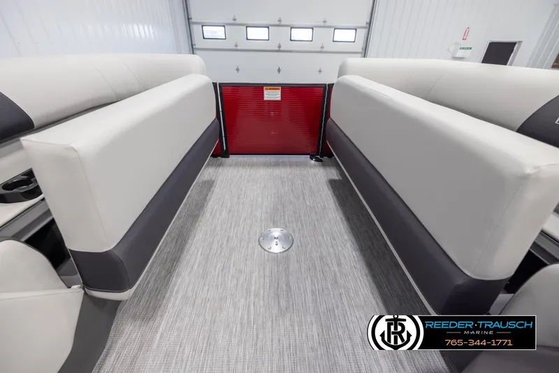 Slide: The Image of 2025 Bennington 22 SSRSE boat interior with gray flooring and cushioned seating. - 19