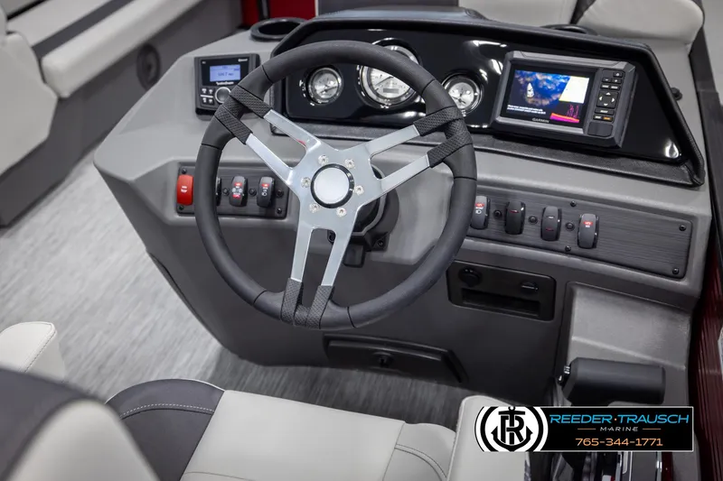 Slide: The Image of 2025 Bennington 22 SSRSE boat dashboard with steering wheel and control panel. - 23