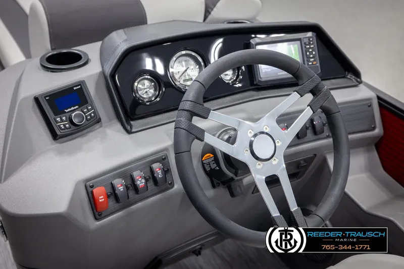 Slide: The Image of 2025 Bennington 22 SSRSE boat dashboard with steering wheel and control panel. - 24