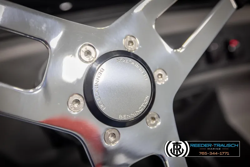 Slide: The Image of Steering wheel of 2025 Bennington 22 SSRSE boat, featuring sleek metallic design. - 25