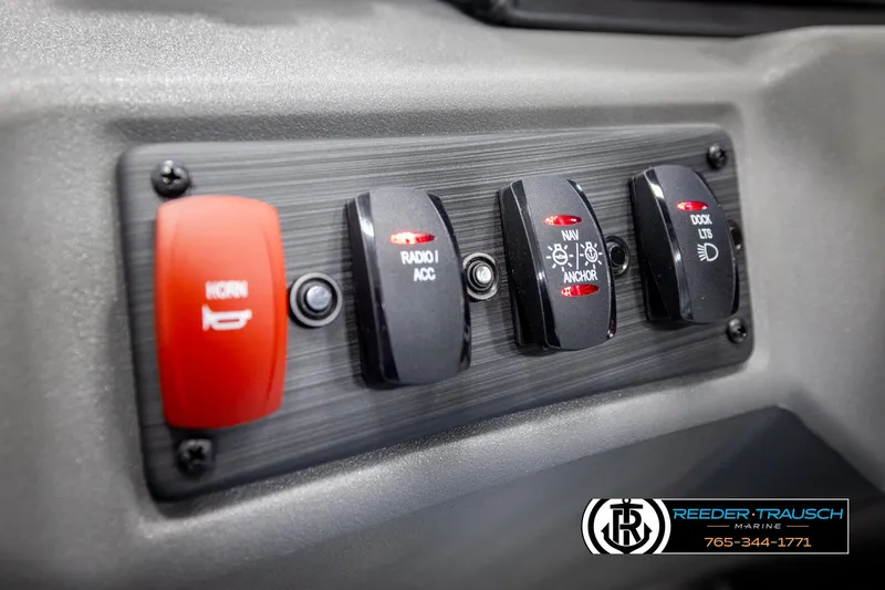 Slide: The Image of Control panel of 2025 Bennington 22 SSRSE boat with switches for horn, radio, navigation, and dock lights. - 26