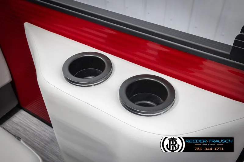 Slide: The Image of 2025 Bennington 22 SSRSE boat interior with dual cup holders and red-white design. - 39