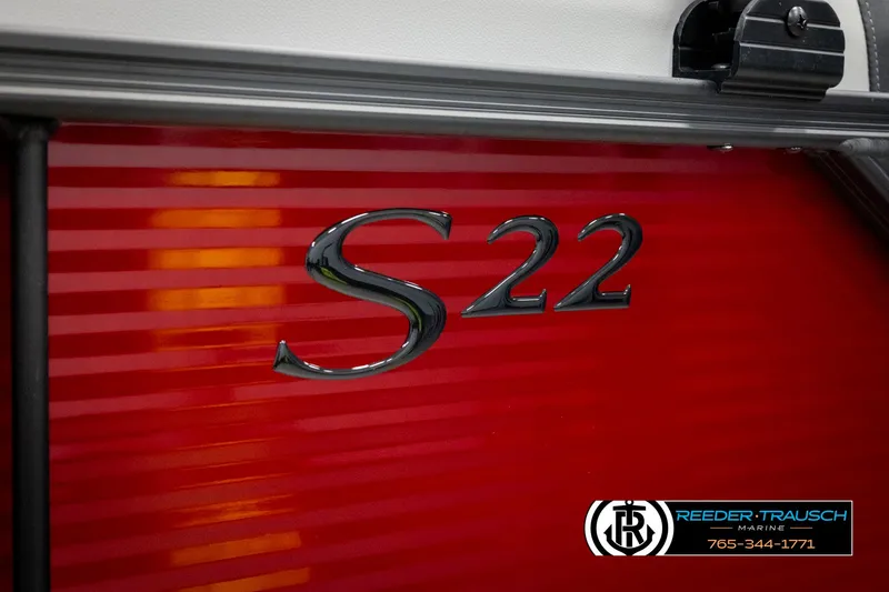 Slide: The Image of Close-up of 2025 Bennington 22 SSRSE boat model emblem on red background. - 44