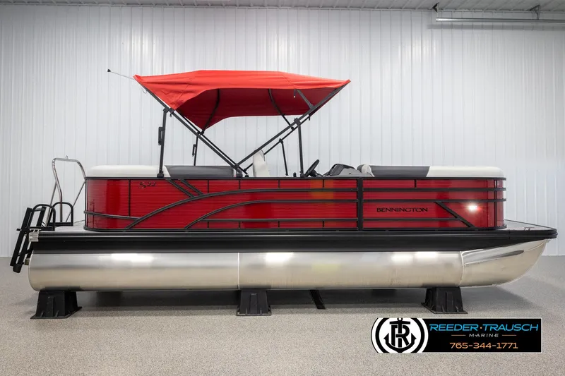 Slide: The Image of 2025 Bennington 22 SSRSE pontoon boat with red canopy in showroom. - 5