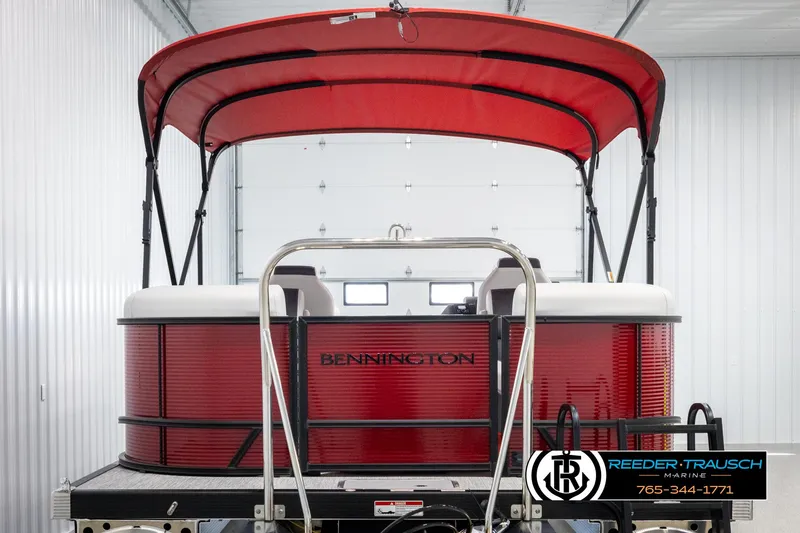 Slide: The Image of 2025 Bennington 22 SSRSE pontoon boat with red canopy in a showroom. - 7
