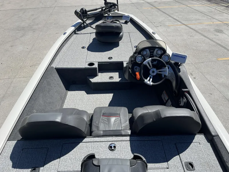 Slide: The Image of 2021 Tracker Pro Team 175 TXW Tournament Edition boat interior with steering console and seating. - 11