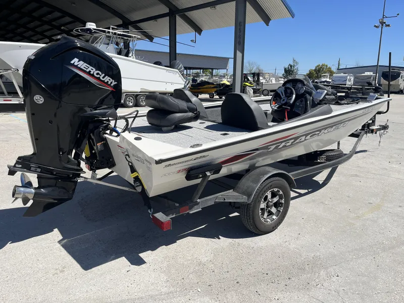 Slide: The Image of 2021 Tracker Pro Team 175 TXW Tournament Edition boat with Mercury engine, parked outdoors. - 3
