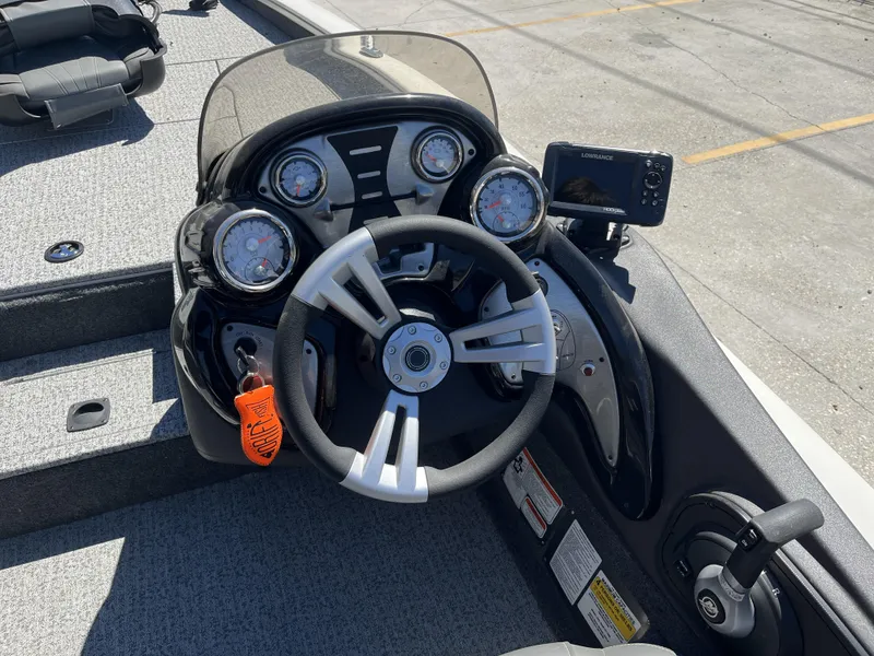 Slide: The Image of 2021 Tracker Pro Team 175 TXW Tournament Edition boat dashboard with steering wheel and gauges. - 5