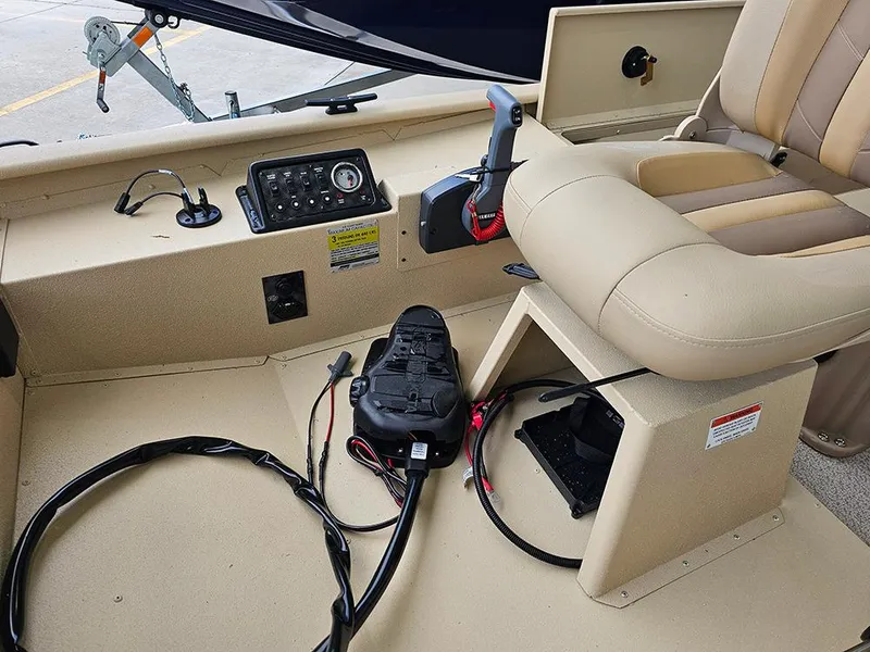Slide: The Image of 2025 G3 Sportsman 1610 SS boat interior with control panel and beige seating. - 15