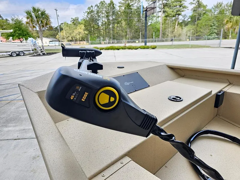 Slide: The Image of 2025 G3 Sportsman 1610 SS boat with trolling motor in a parking area. - 16