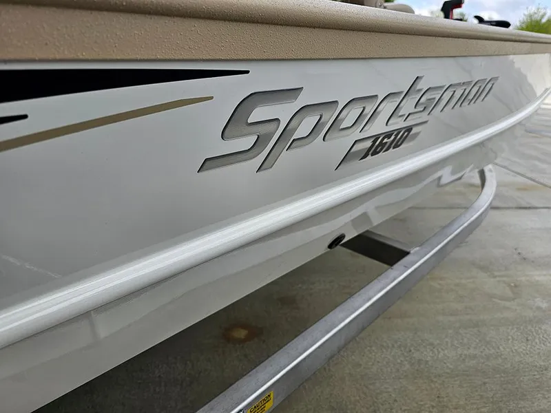 Slide: The Image of 2025 G3 Sportsman 1610 SS boat side view with logo detail. - 21