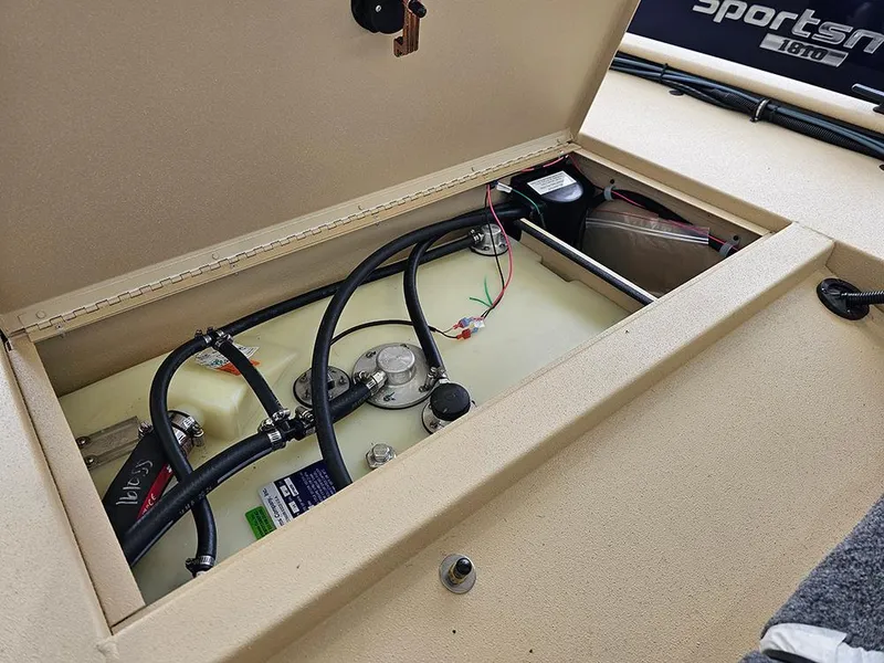 Slide: The Image of 2025 G3 Sportsman 1610 SS boat compartment with wiring and battery components. - 9