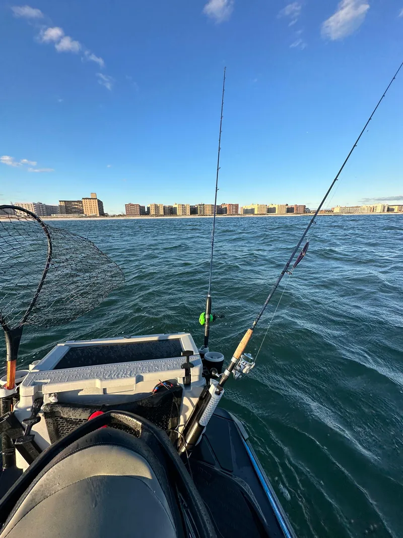 Slide: The Image of 2019 Sea-Doo GTR 230 on water, equipped for fishing, with cityscape in background. - 13