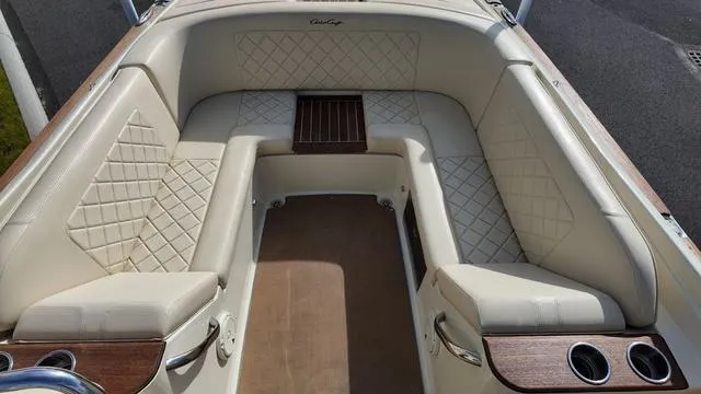 Slide: The Image of 2017 Chris-Craft Launch 27 boat interior with beige leather seating and wood accents. - 10